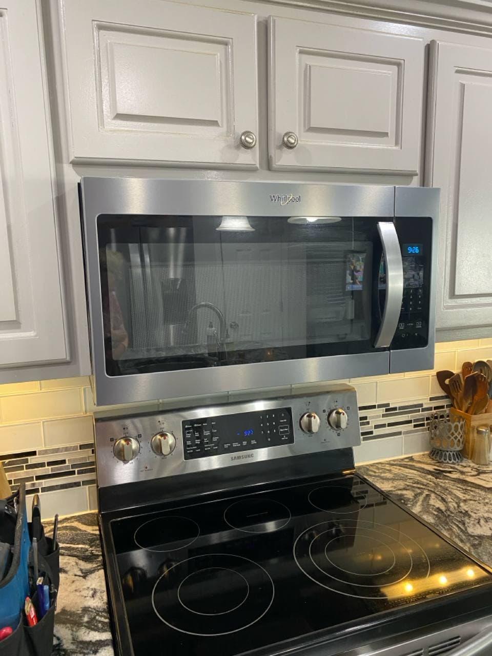 Whirlpool over-the-range microwave installed above a Samsung range