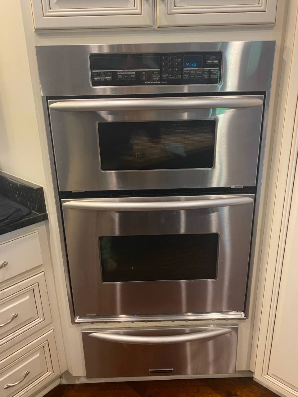 KitchenAid double wall oven installed in cherry wood cabinetry